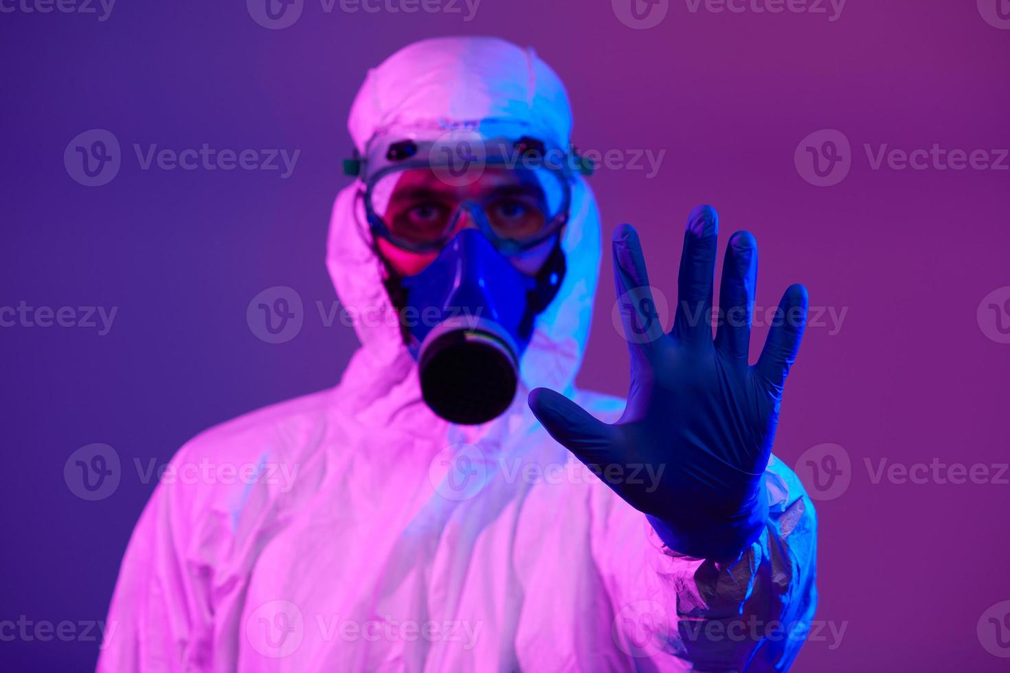 Doctor wearing protective biological suit and mask due to coronavirus photo