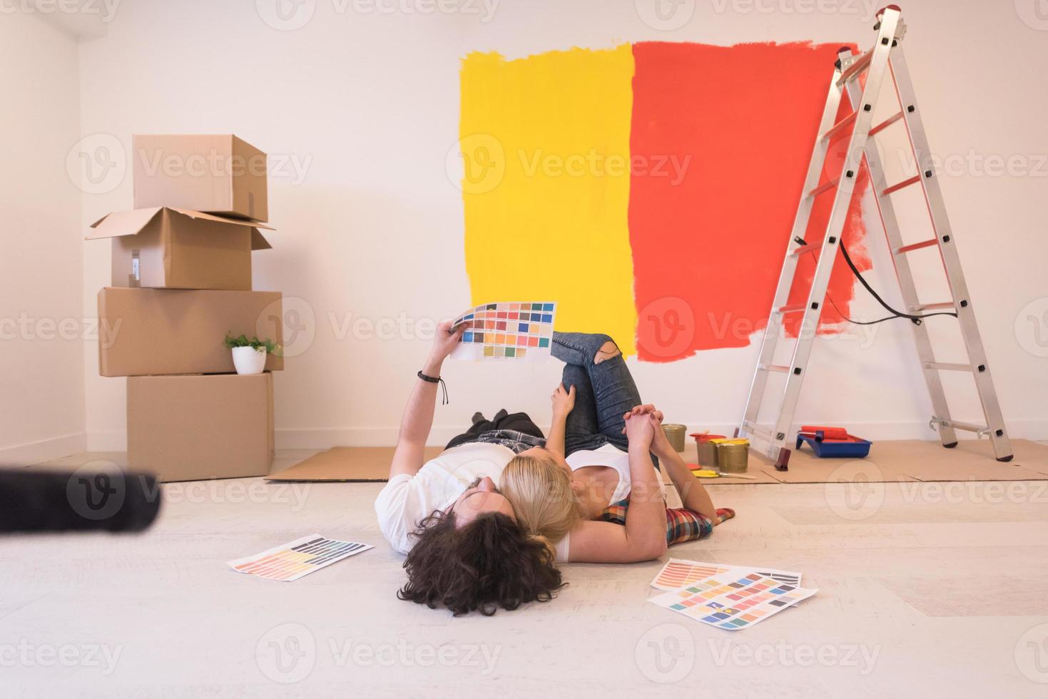 Happy young couple relaxing after painting photo