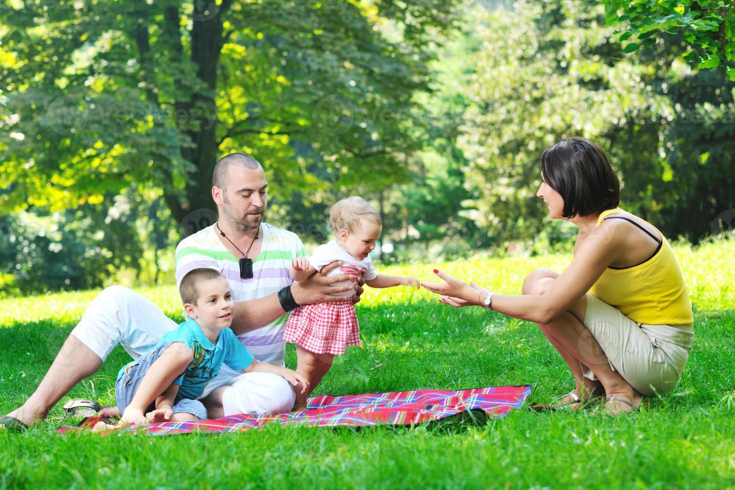 happy young couple with their children have fun at park photo