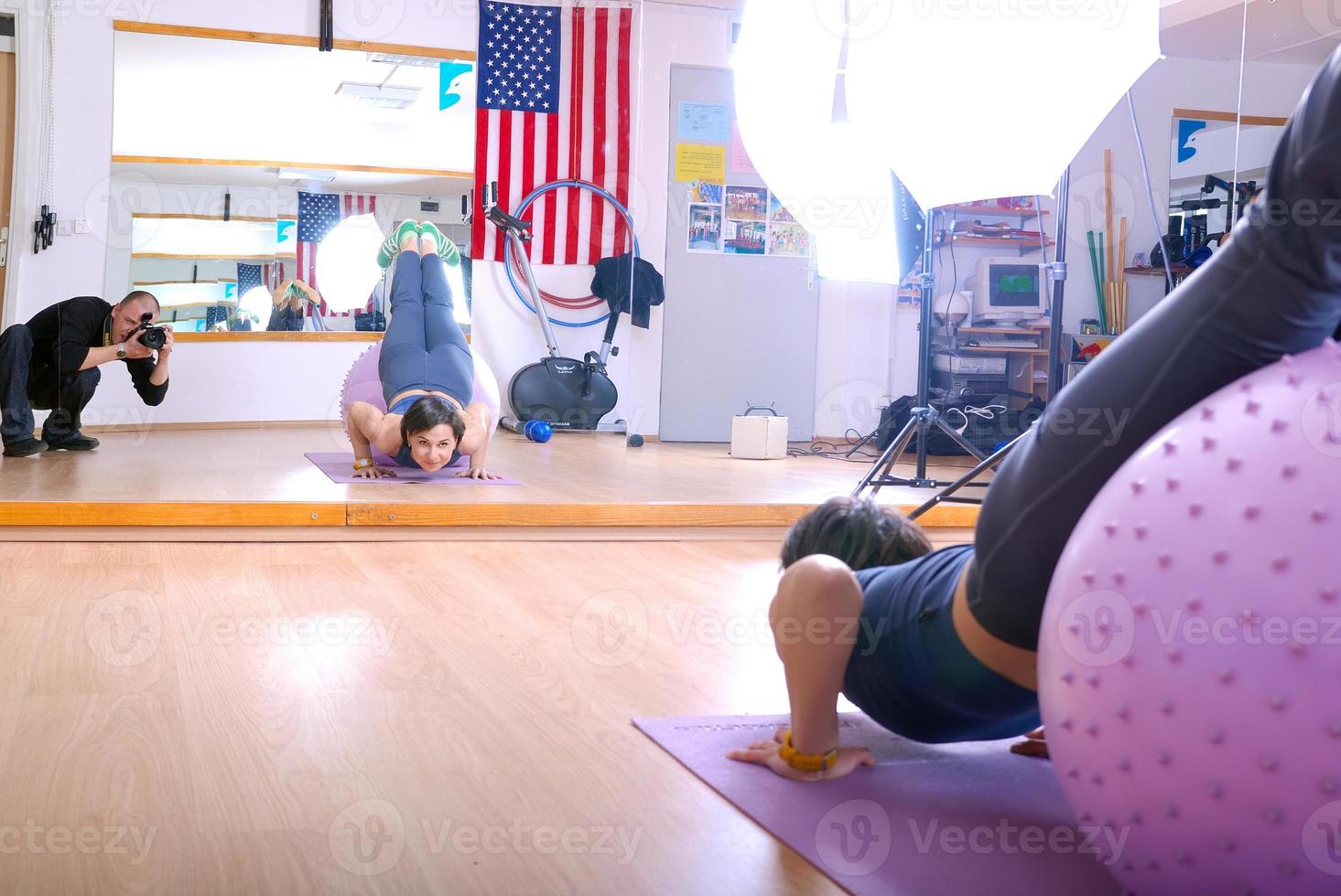 .happy young woman exercising in a gym photo