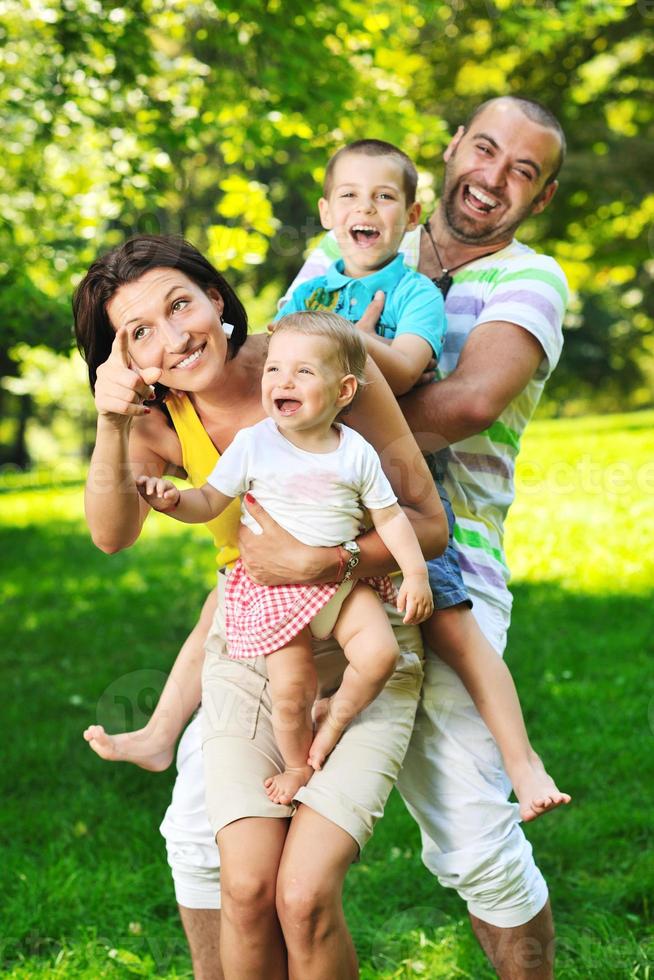 happy young couple with their children have fun at park photo