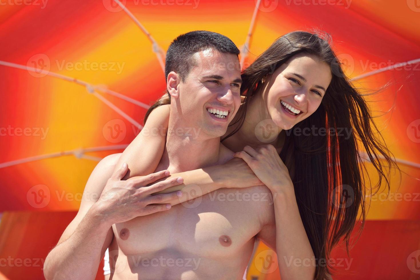 happy couple have fun on the beach photo