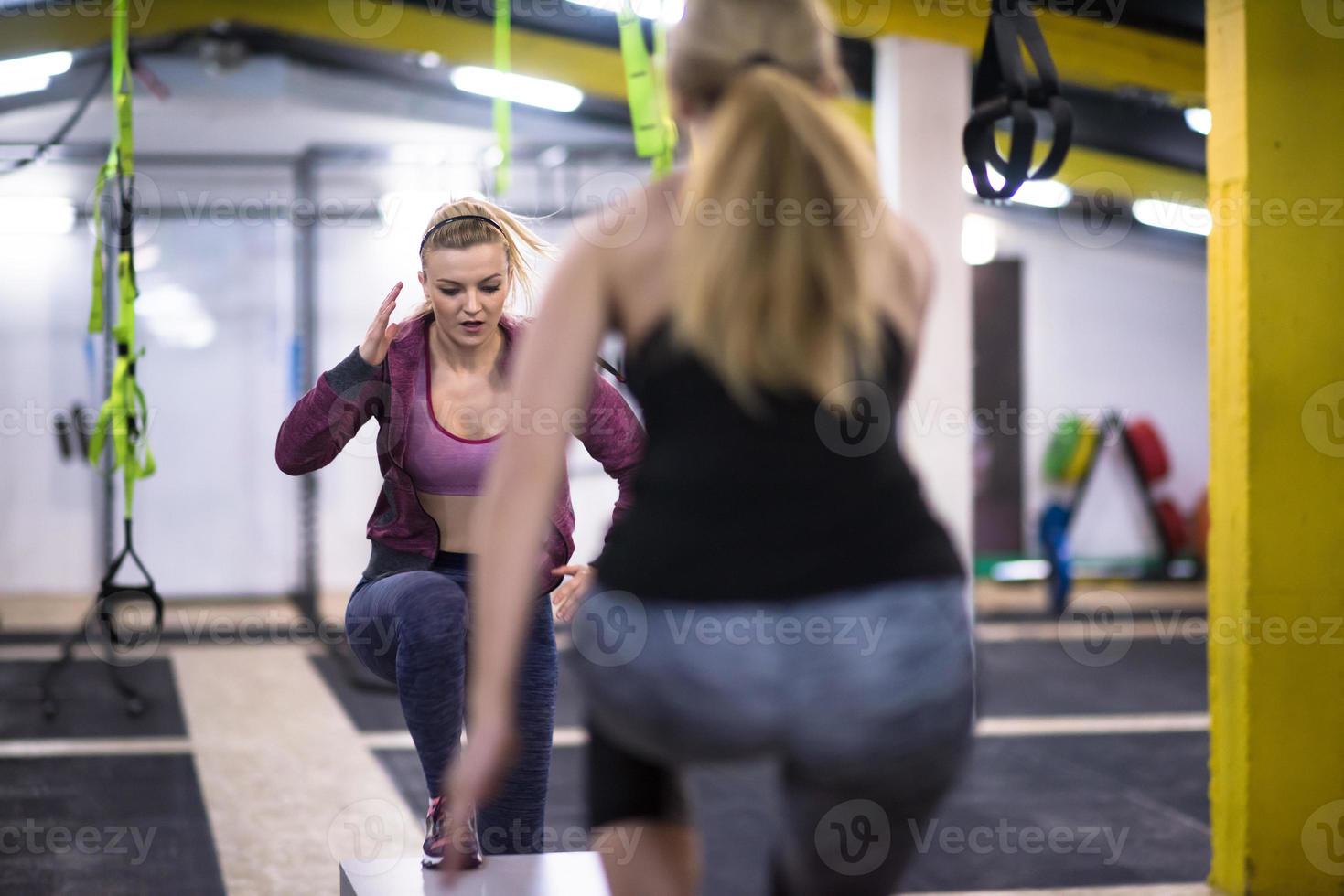 athletes working out  jumping on fit box photo