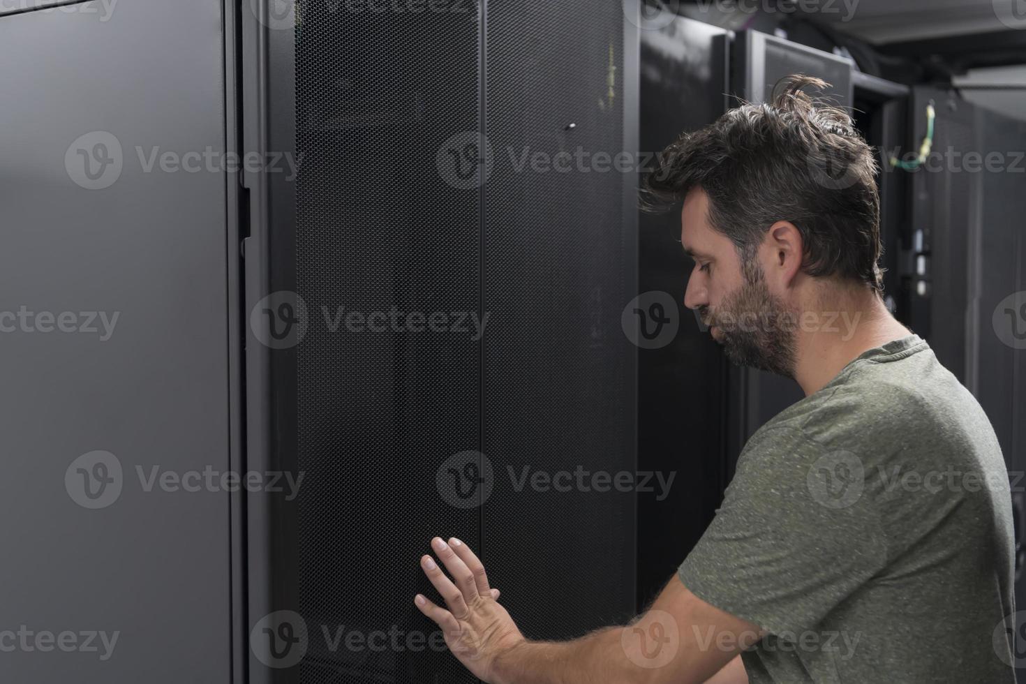 Technicians team updating hardware inspecting system performance in super computer server room or cryptocurrency mining farm. photo