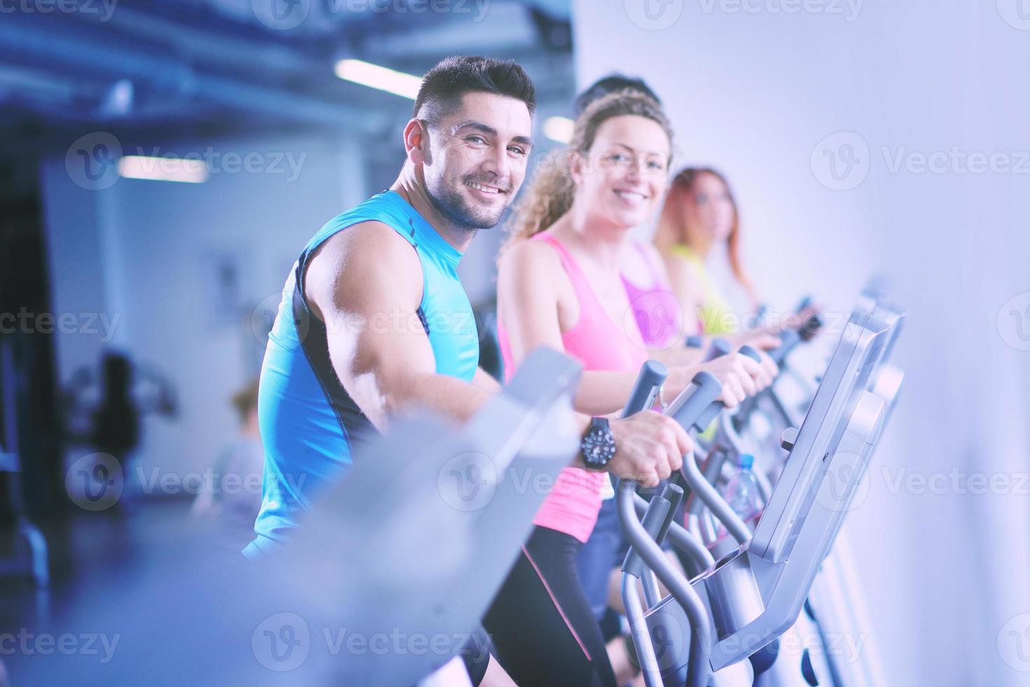 Group of people running on treadmills photo
