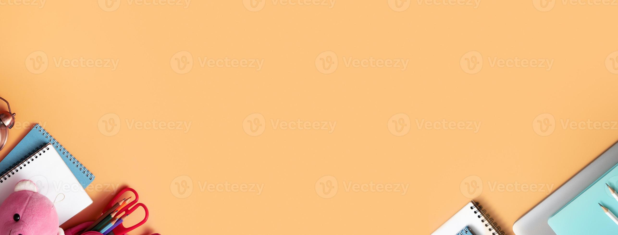 Banner with notebooks, alarm clock and stationary on colored background. Copy space. Back to school sale concept photo