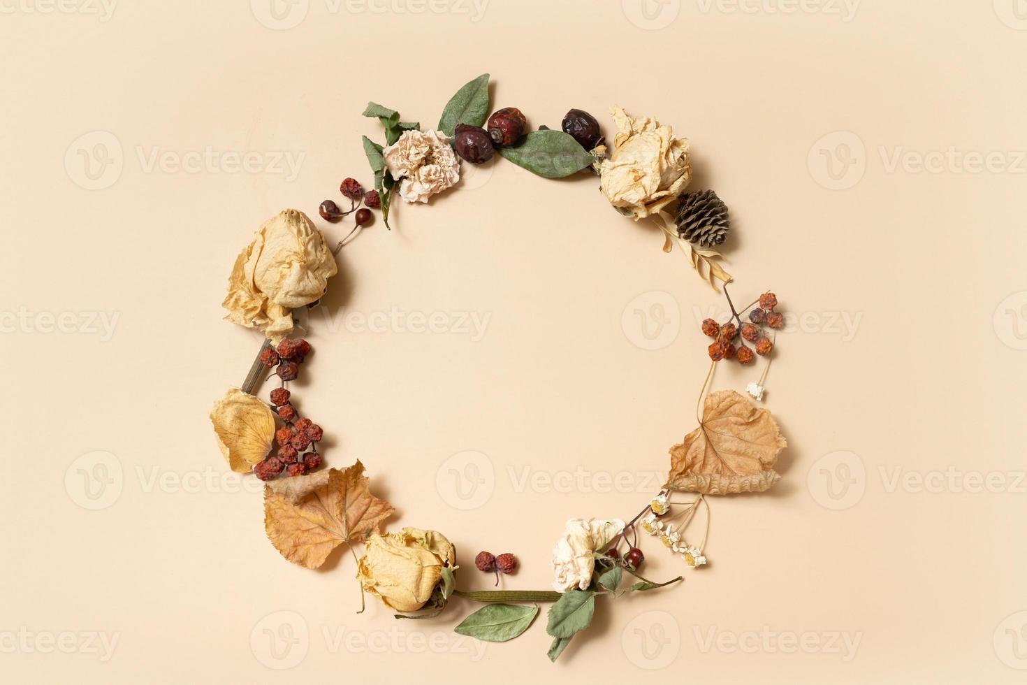 Autumn composition. Wreath made of dried leaves on pastel beige background. Autumn, fall concept. Flat lay, top view, copy space photo