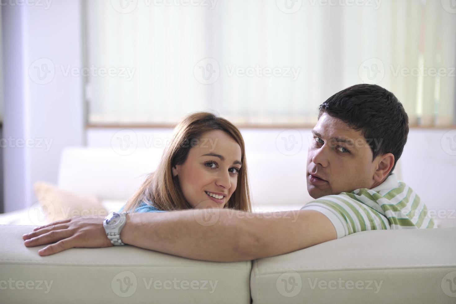 couple relax at home on sofa in living room photo