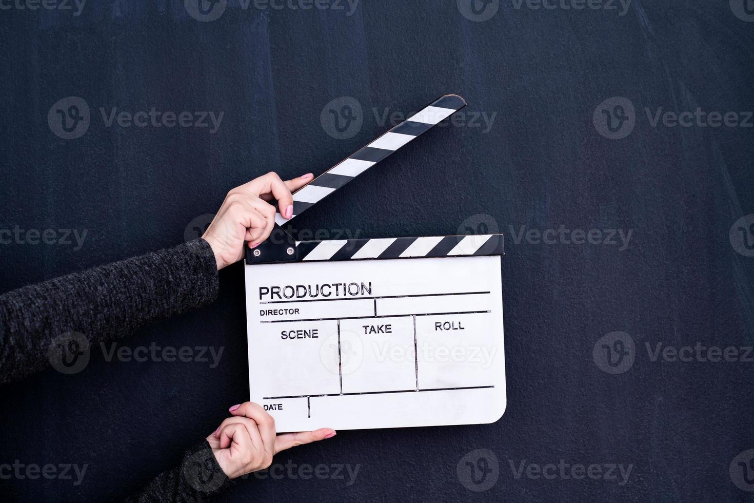 movie clapper on black chalkboard background photo