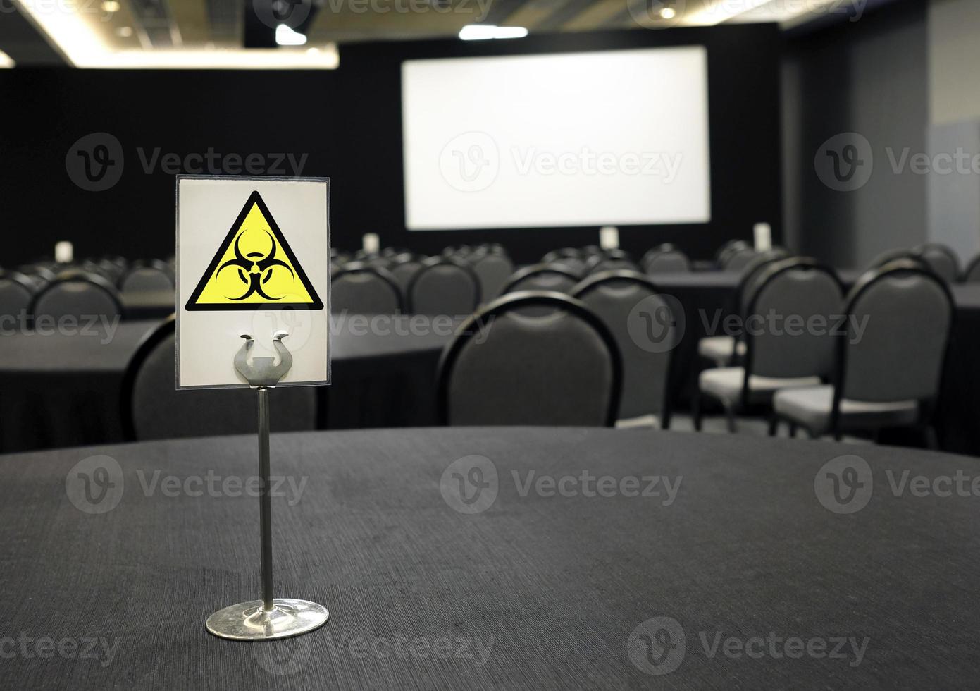 Coronavirus and cancellations - Empty conference center and bio hazard sign photo