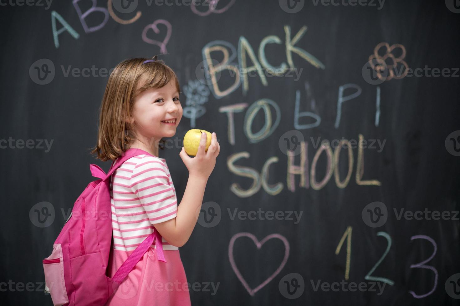 happy child with apple and back to school drawing in background photo