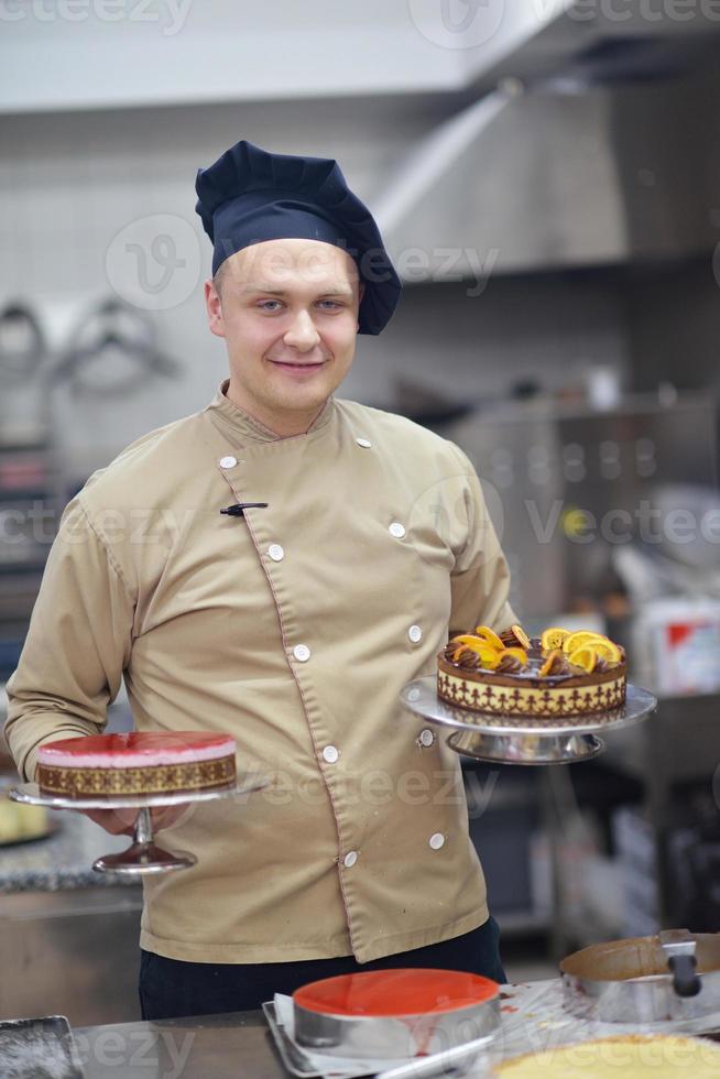 chef preparing desert cake in the kitchen photo