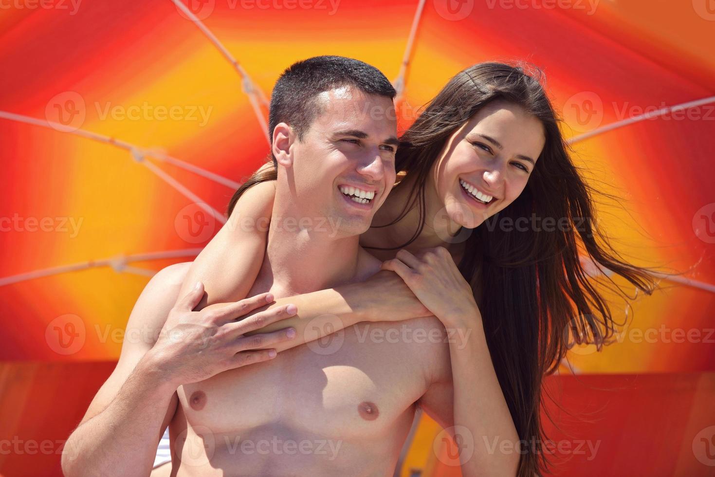 happy couple have fun on the beach photo