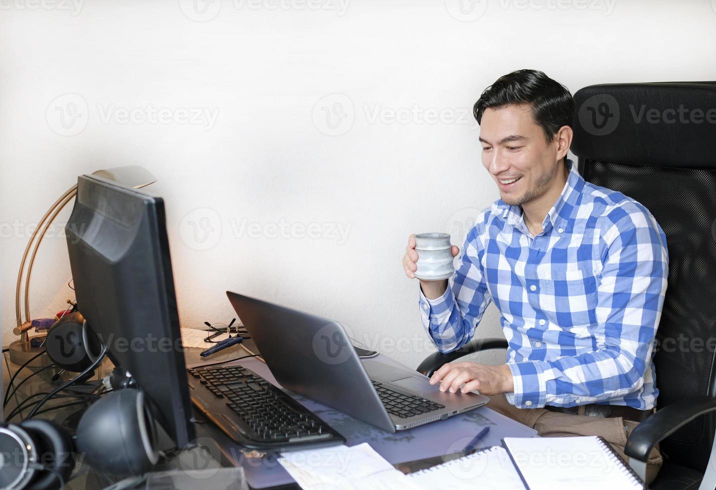 A man working from home at a desk photo
