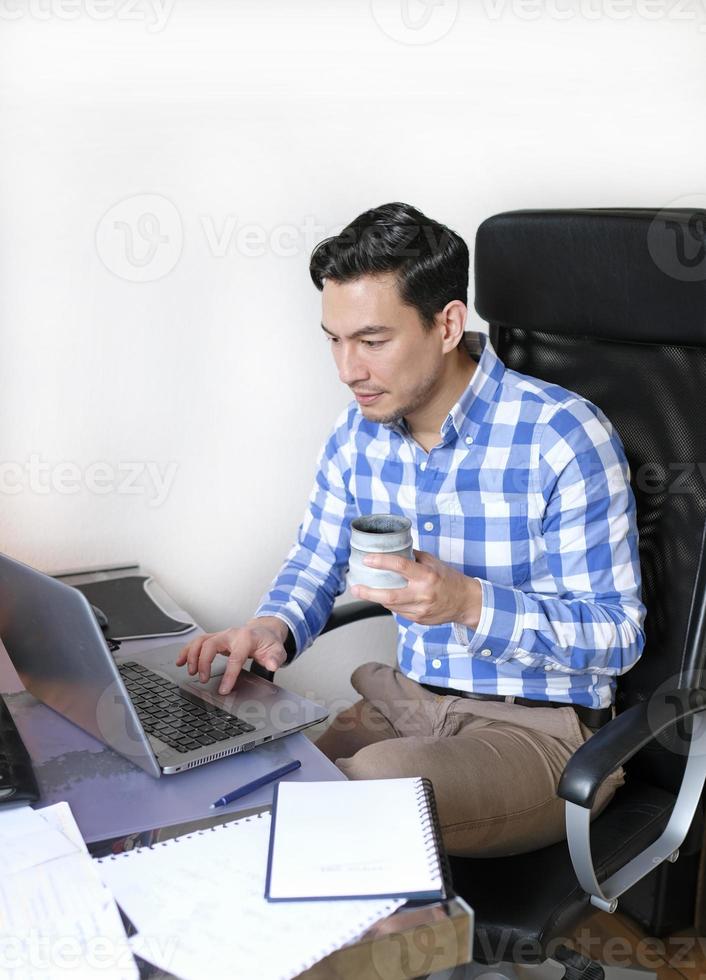A man working from home at a desk photo
