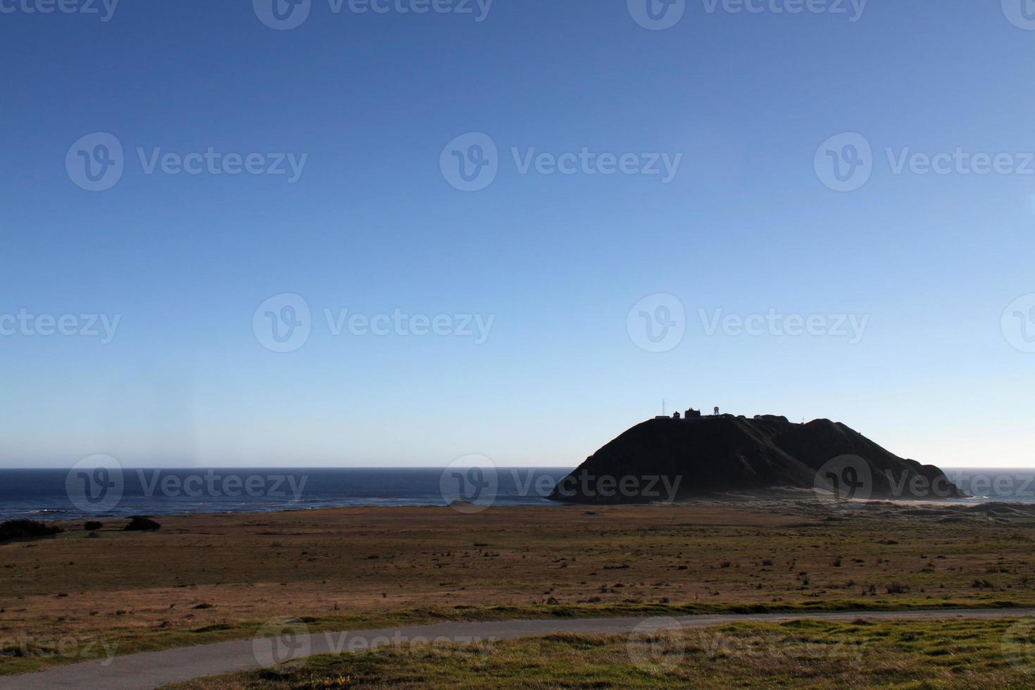 Lone house on a hill along the coast in California photo