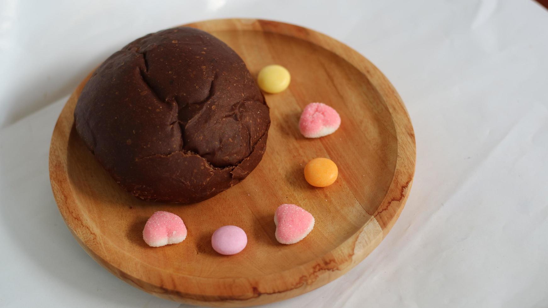 Dark brown bread and six cute candies photo