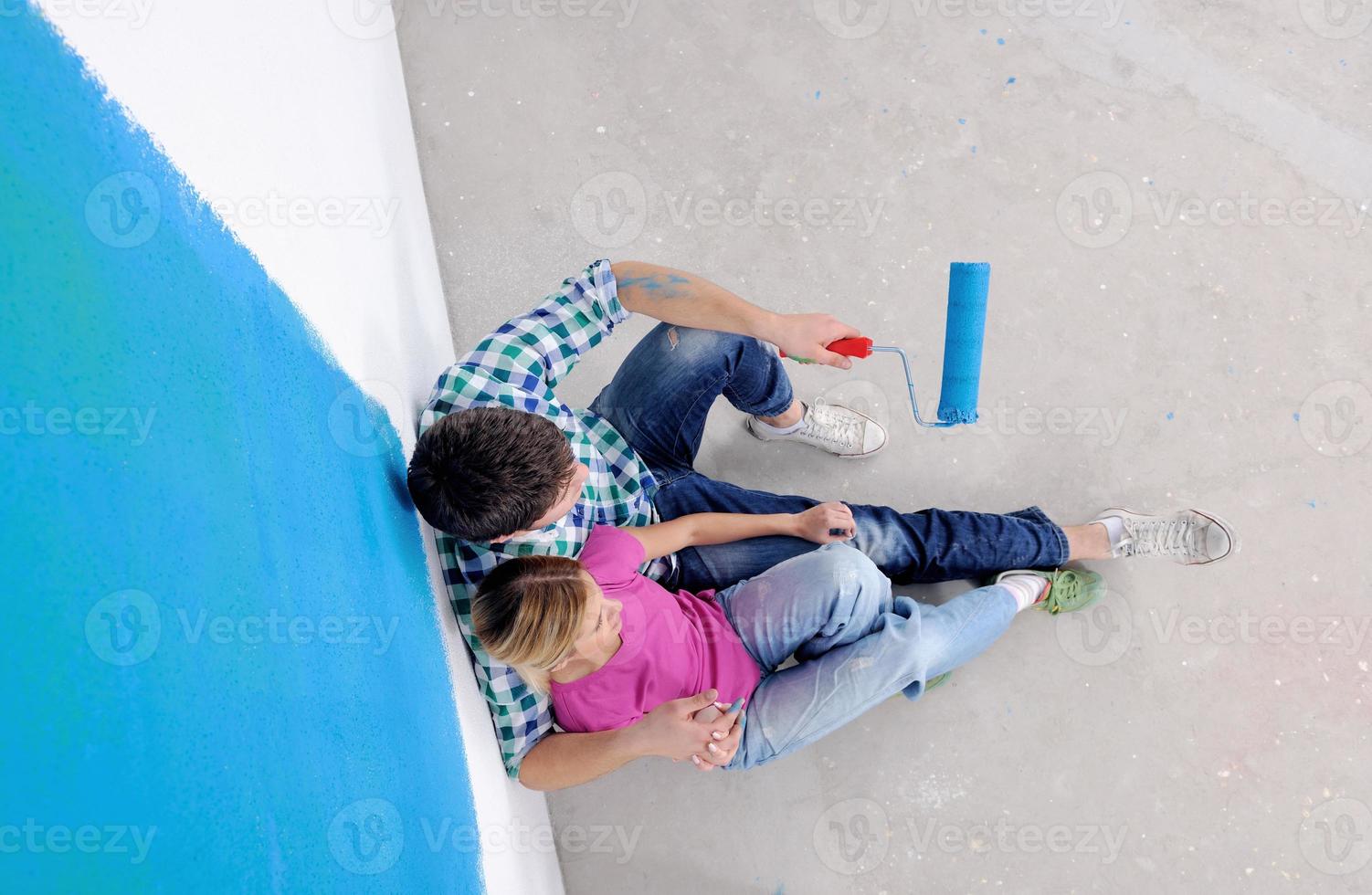 happy young cople relaxing after painting in new home photo