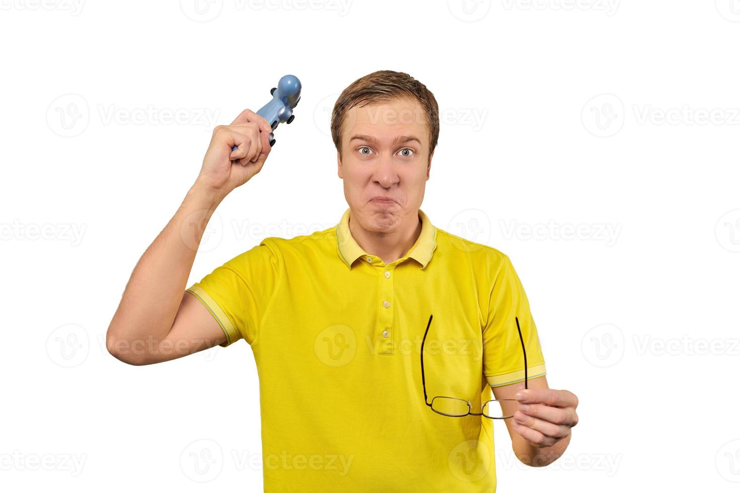 Angry gamer with wireless gamepad dressed in yellow T-shirt isolated on white background photo