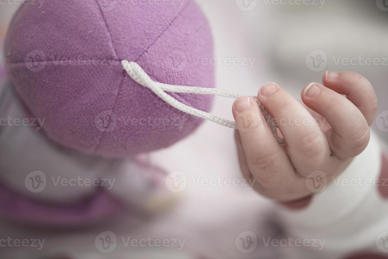 cute little baby playing with hands and smiling photo