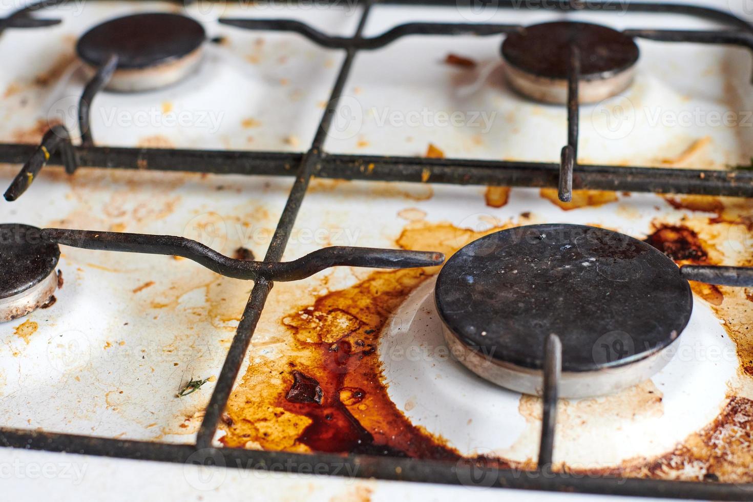 Dirty stove with food leftovers photo