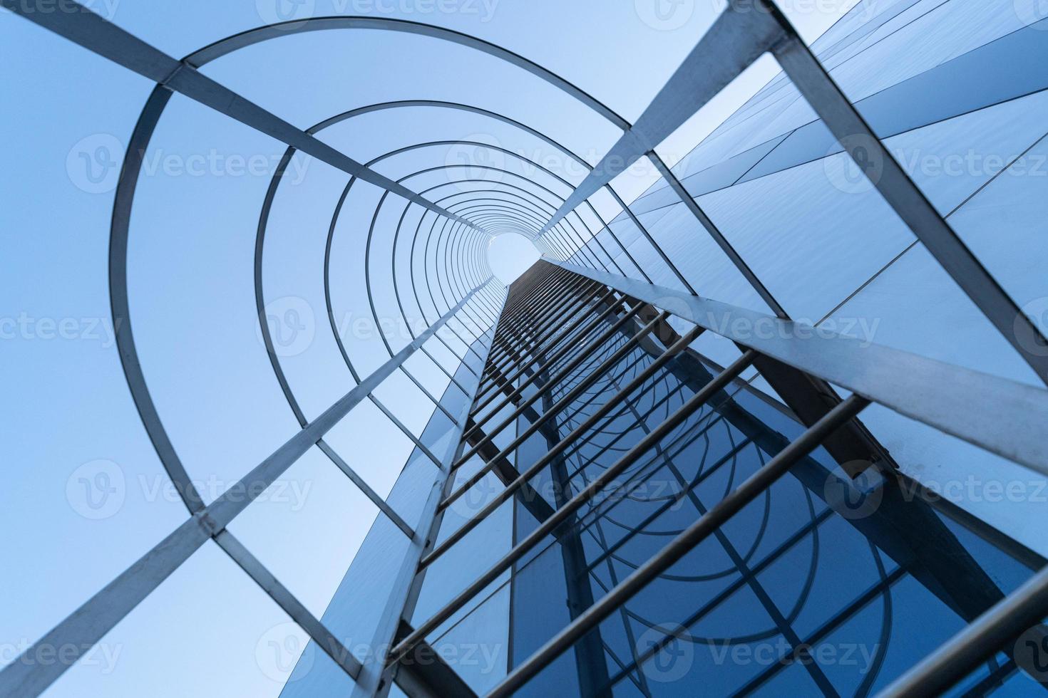 Fire escape staircase of modern business center. Stairway to Heaven concept. Emergency fire exit. Bottom view photo