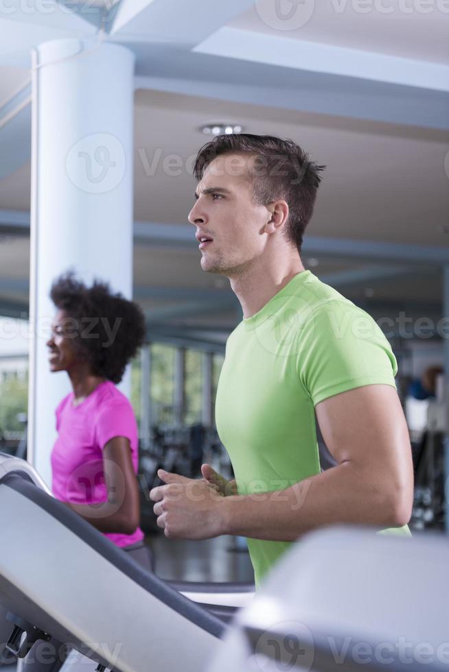 people exercisinng a cardio on treadmill in gym photo