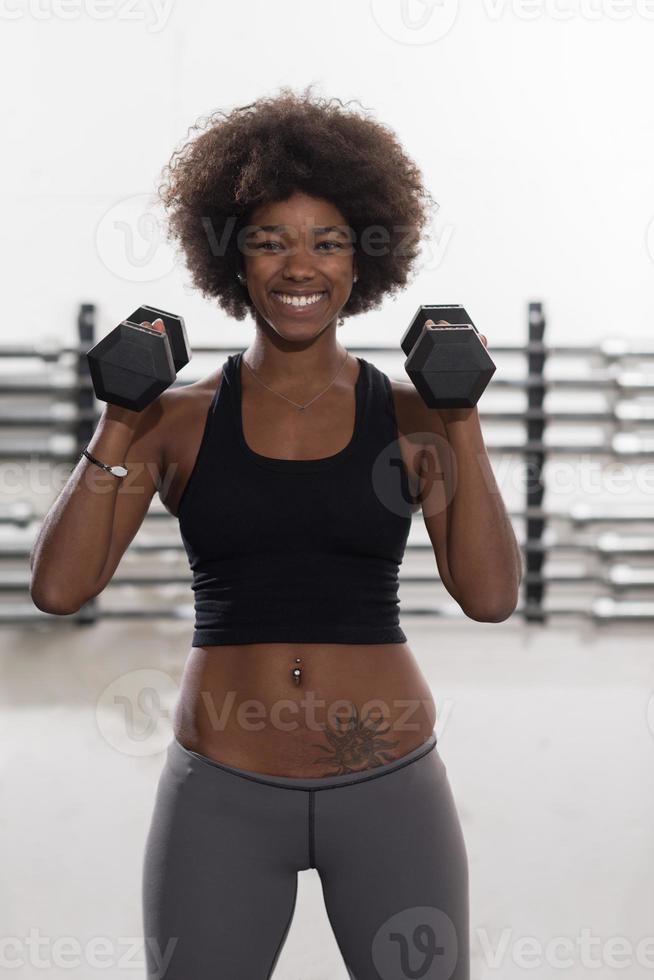 black woman doing bicep curls photo