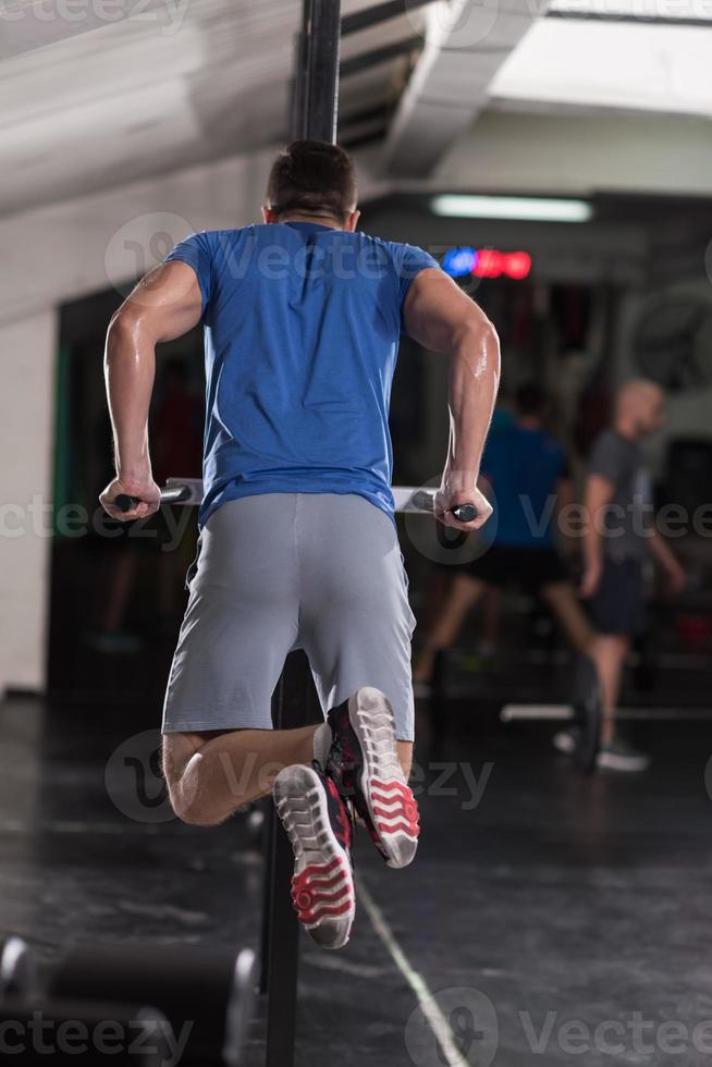 man doing exercises parallel bars photo