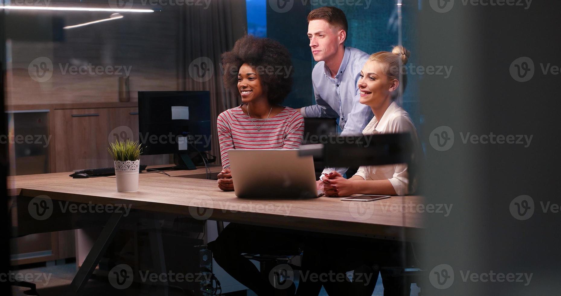 Multiethnic startup business team in night office photo