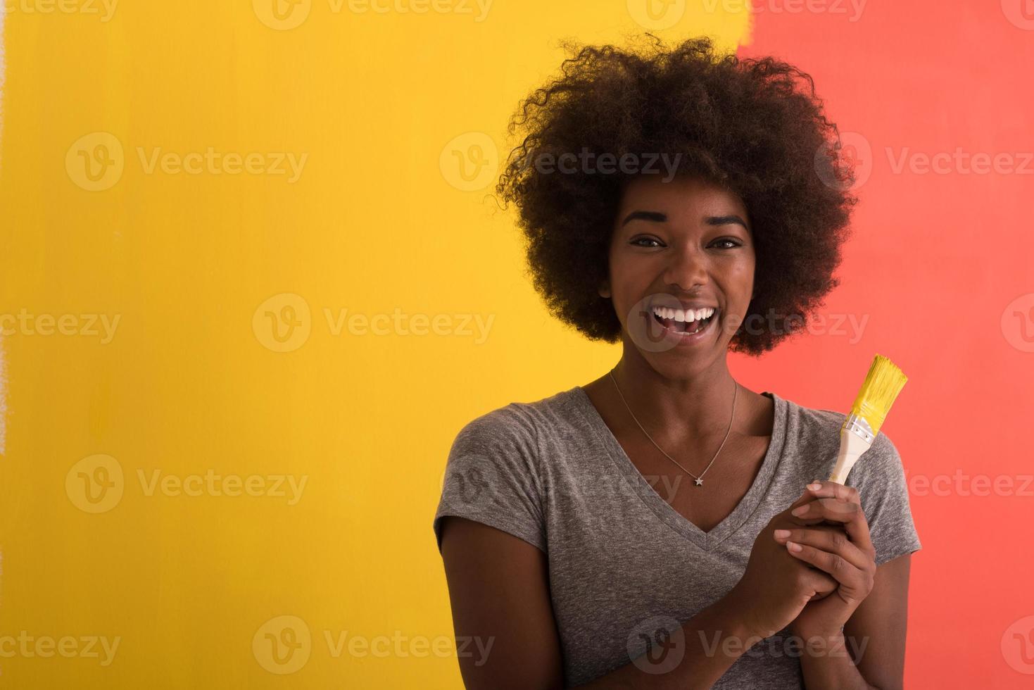 black woman painting wall photo