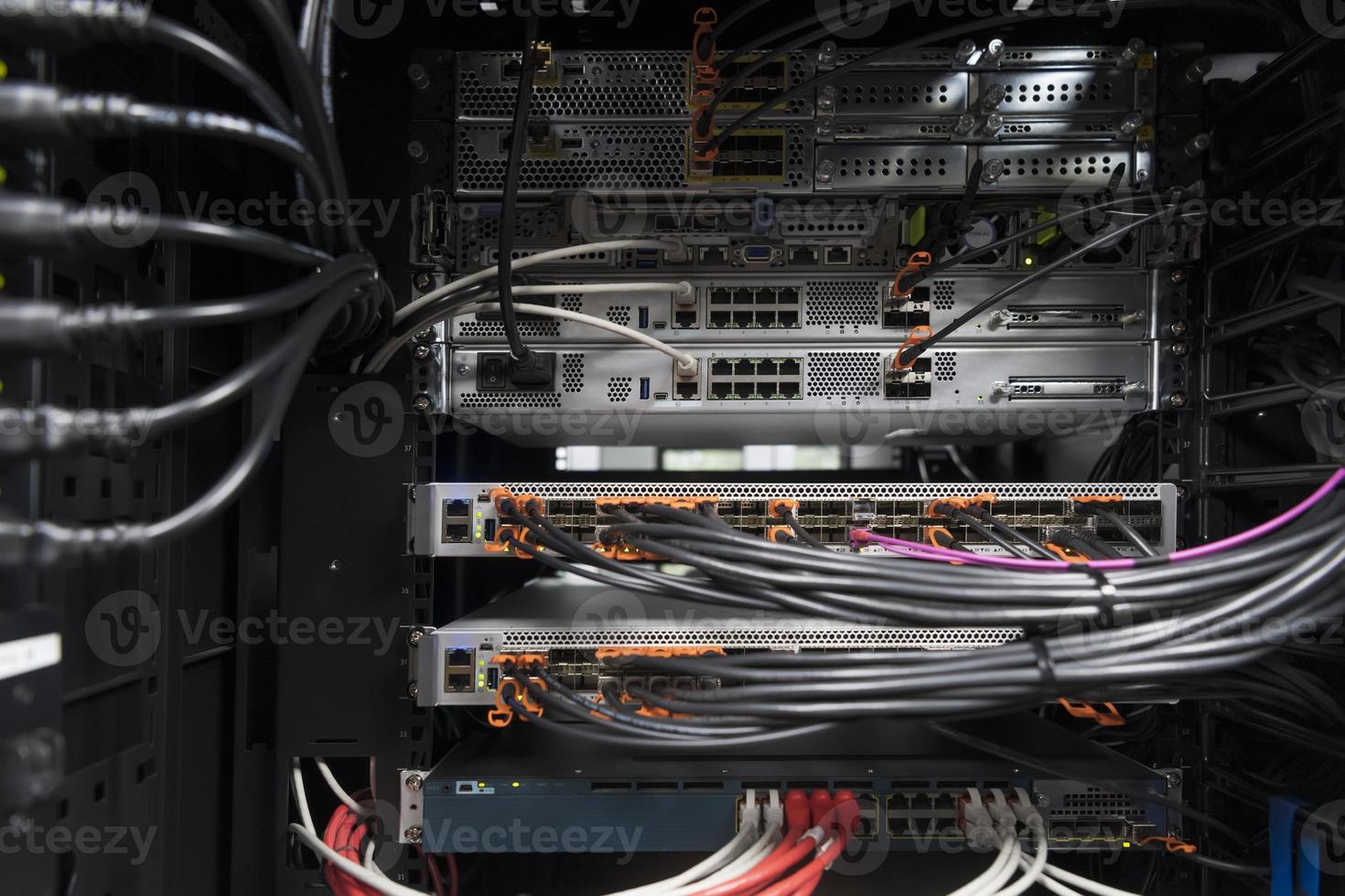 network server room closeup on fiber optic hub or switch for digital communications and internet in mainframe corporate business data center supercomputer. photo