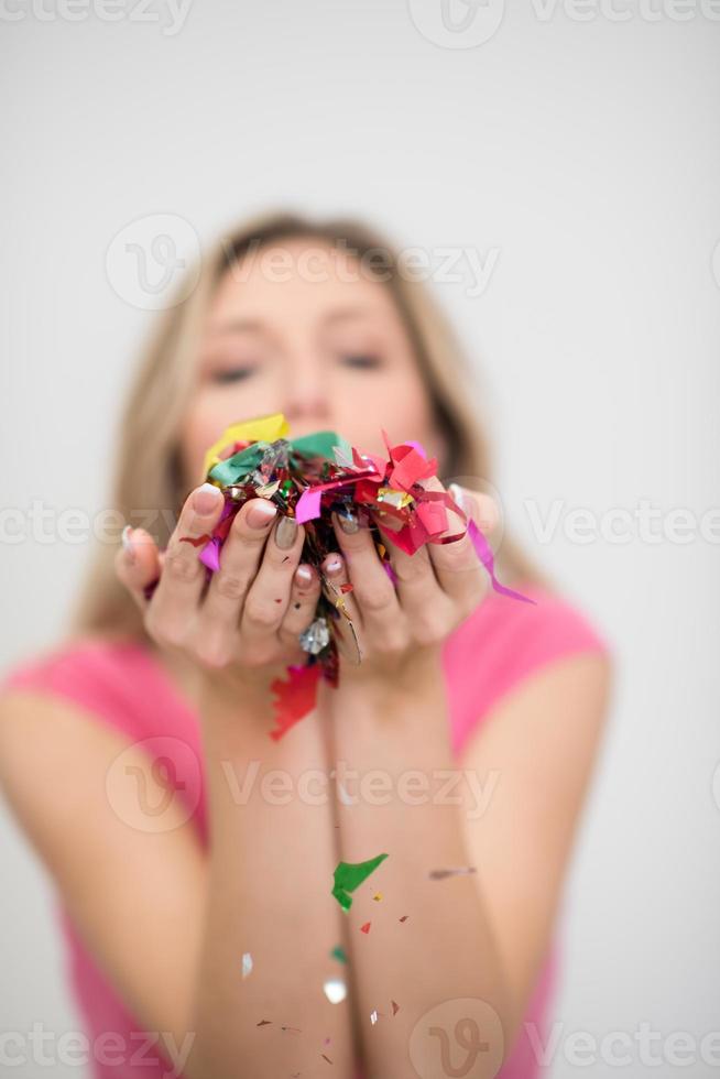 woman blowing confetti in the air photo