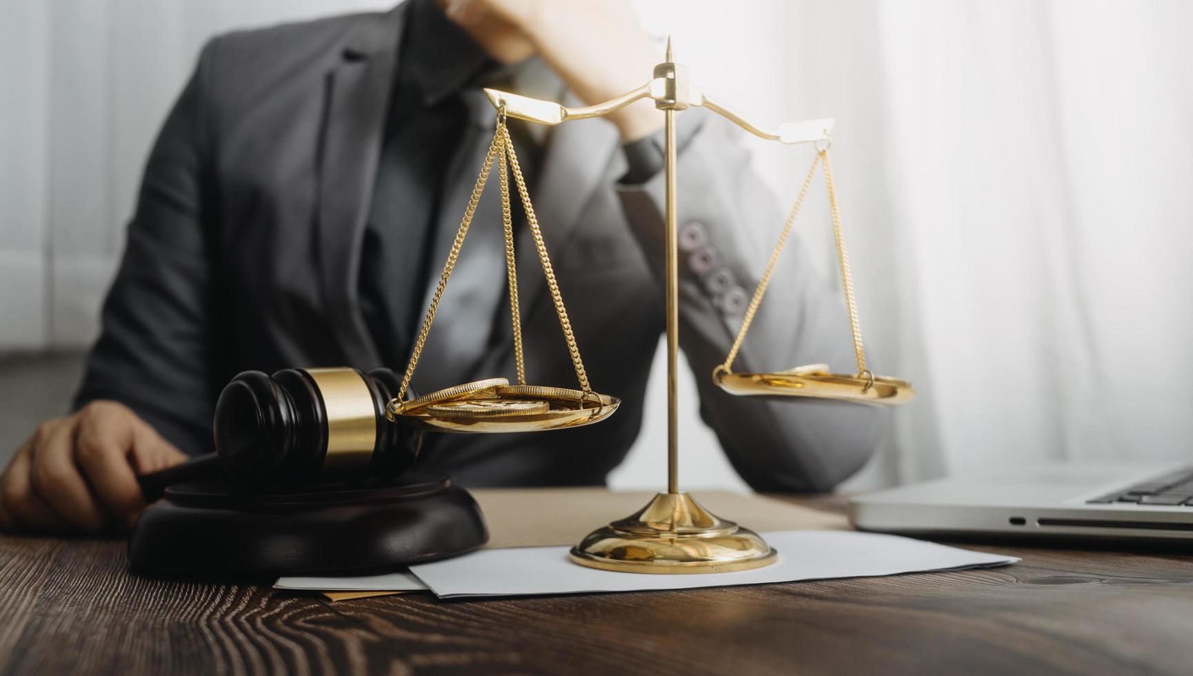 Business and lawyers discussing contract papers with brass scale on desk in office. Law, legal services, advice, justice and law concept picture with film grain effect photo