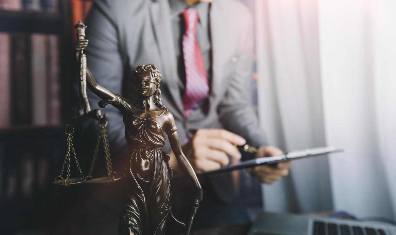 Business and lawyers discussing contract papers with brass scale on desk in office. Law, legal services, advice, justice and law concept picture with film grain effect photo