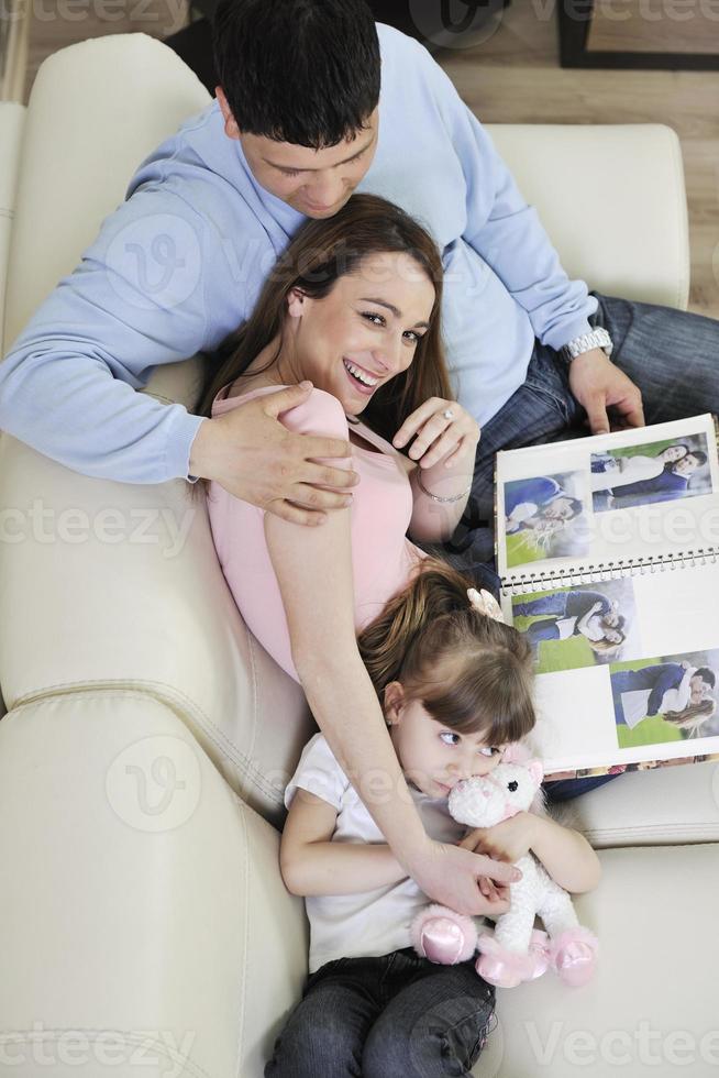 happy family looking photos at home