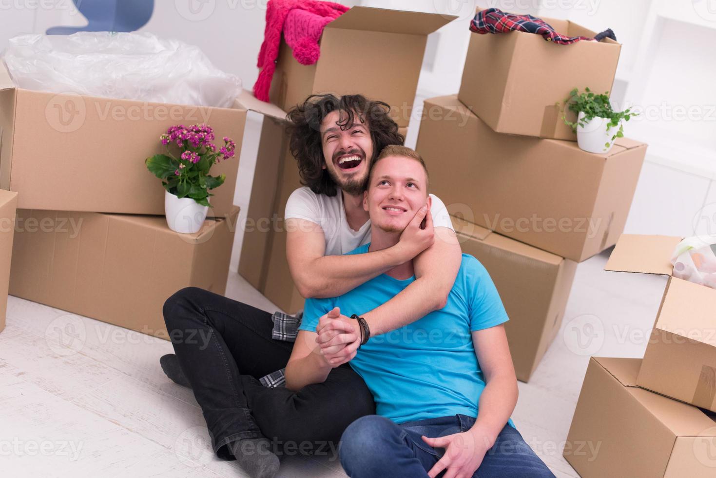 young  gay couple moving  in new house photo