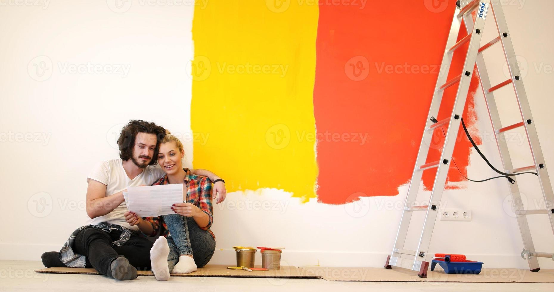 Happy young couple relaxing after painting photo