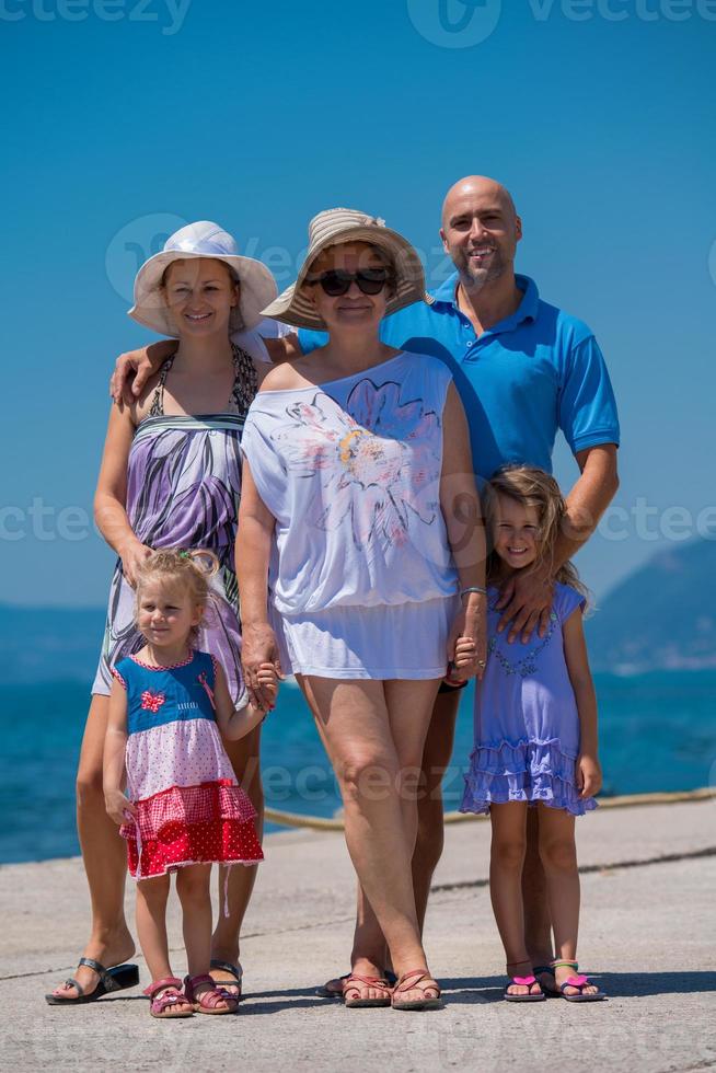 Portrait of happy multi generation family by the sea photo