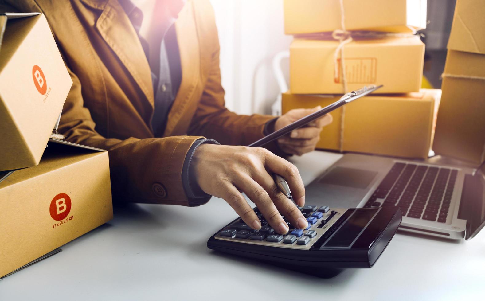 Online sales ideas for work at home. Asian man is answering phone calls. To accept orders from online customers.Very good sale. online Business and E-commerce.Online shop photo