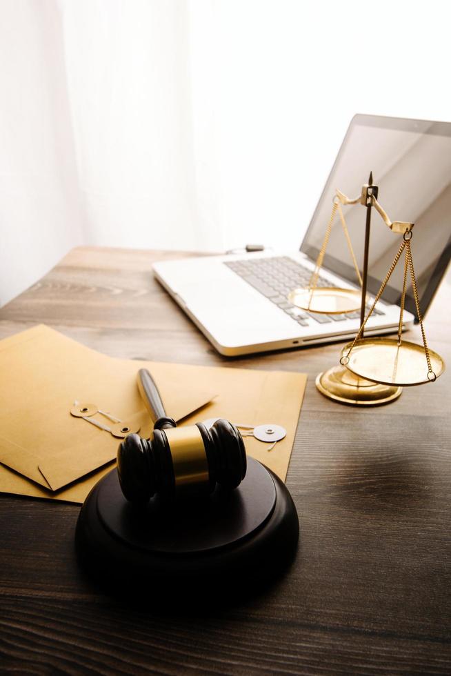 Business and lawyers discussing contract papers with brass scale on desk in office. Law, legal services, advice, justice and law concept picture with film grain effect photo