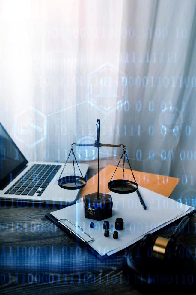 Justice and law concept.Male judge in a courtroom with the gavel, working with, computer and docking keyboard, eyeglasses, on table in morning light photo