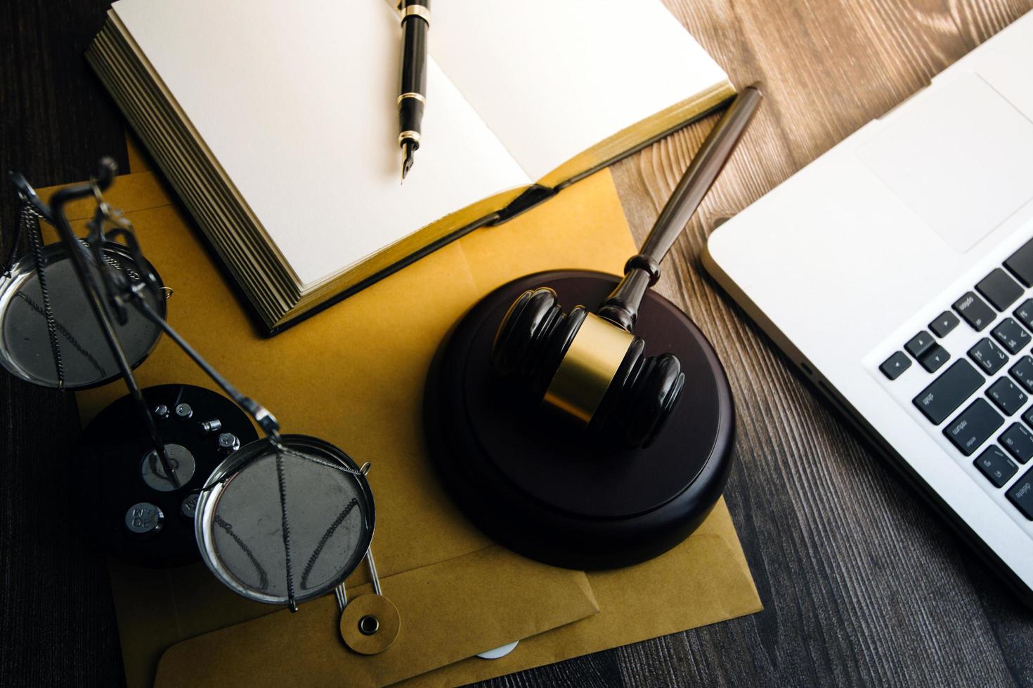 Business and lawyers discussing contract papers with brass scale on desk in office. Law, legal services, advice, justice and law concept picture with film grain effect photo