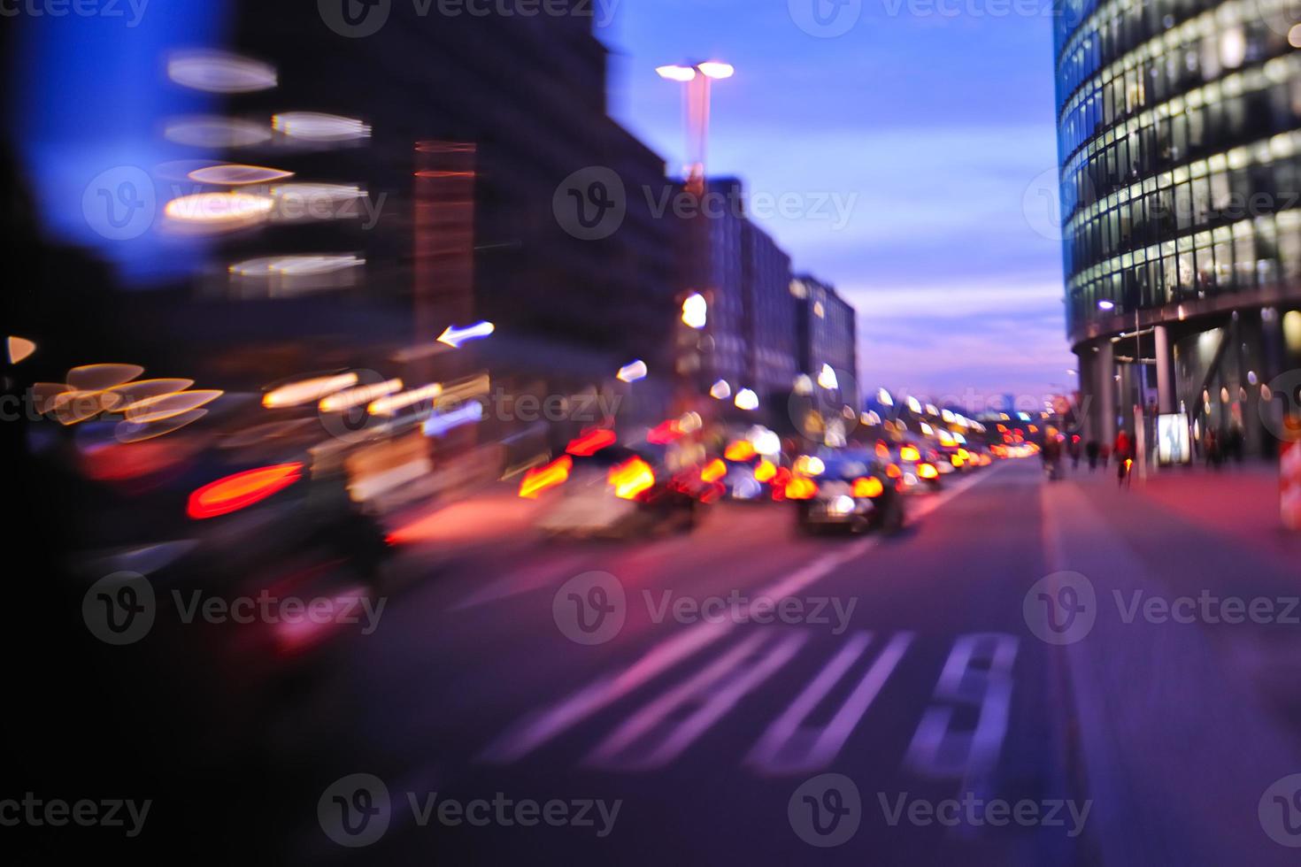City night with cars motion blurred light in busy street photo