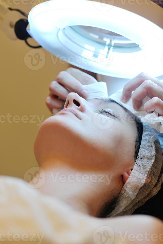 woman with facial mask in cosmetic studio photo