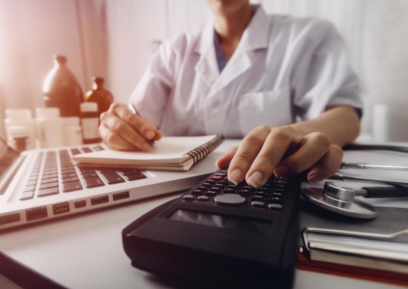 Business accounting concept, Business man using calculator with computer laptop, budget and loan paper in office. photo