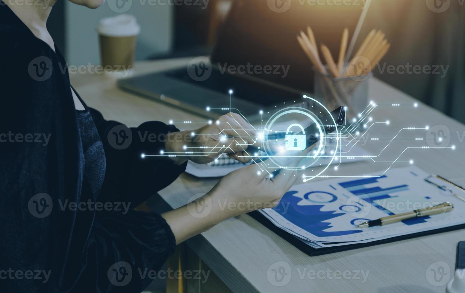 Cybersecurity and privacy concepts to protect data. Lock icon and internet network security technology. Businessman protecting personal data on smart phone with virtual screen interfaces. photo