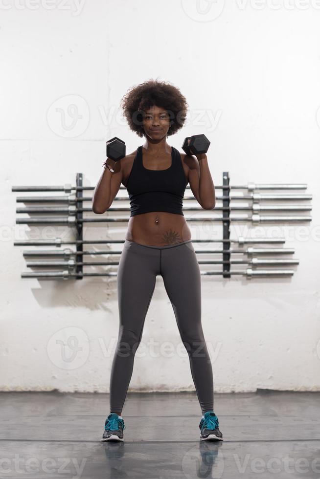 black woman doing bicep curls photo