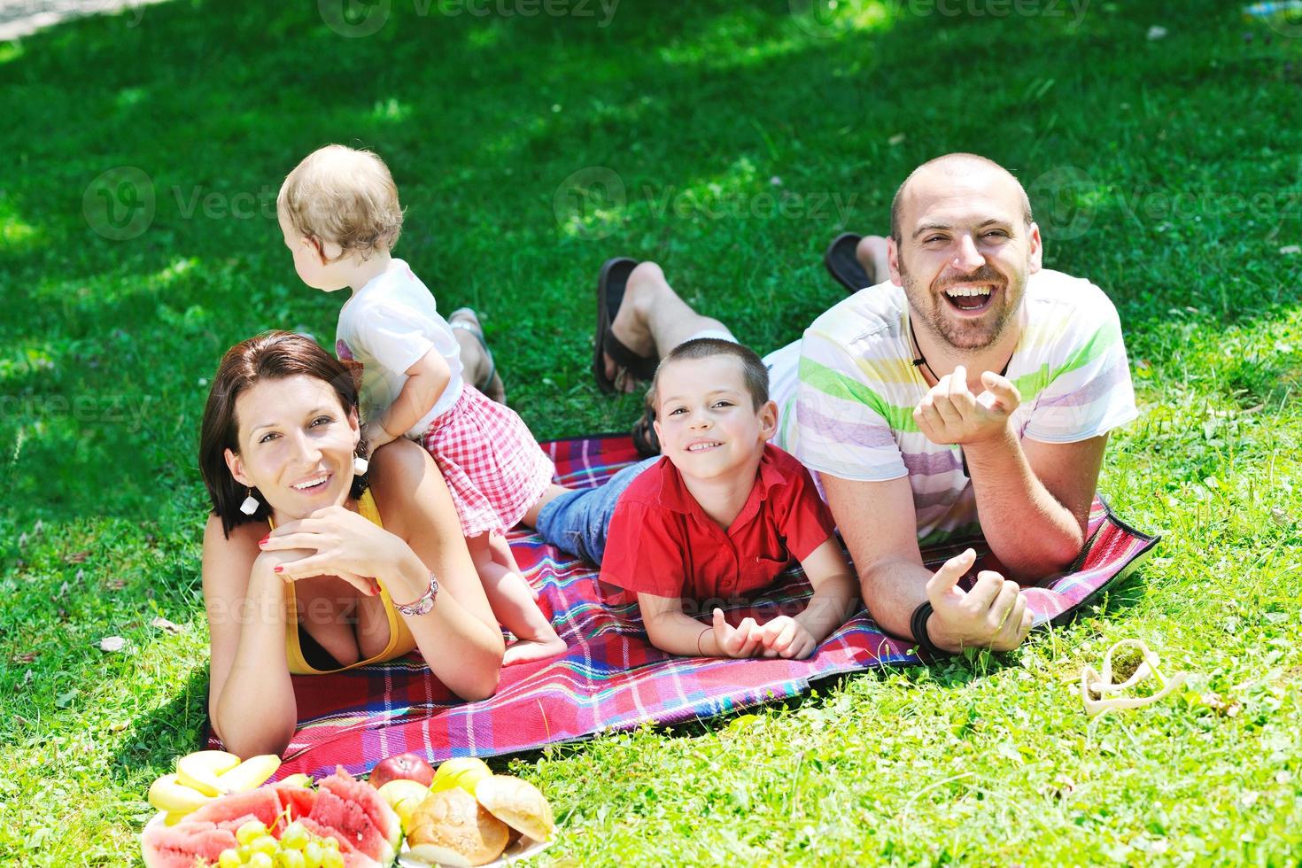 happy young couple with their children have fun at park photo