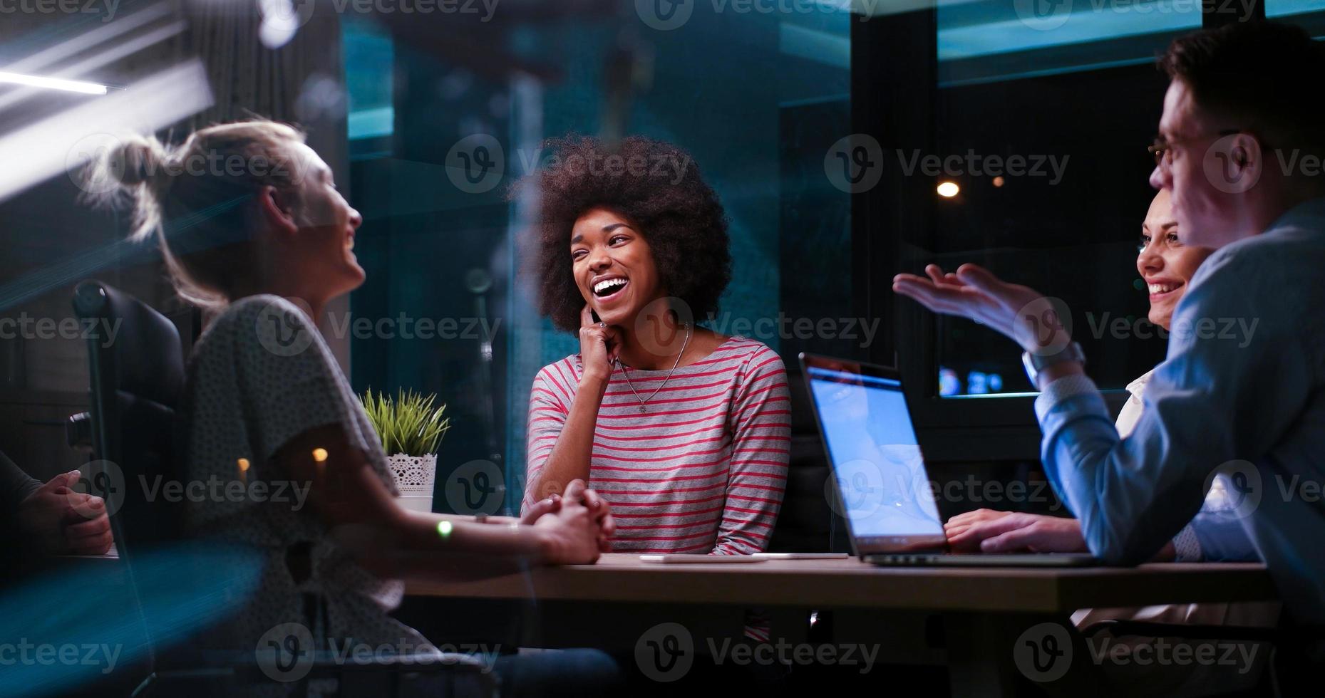 Multiethnic startup business team in night office photo